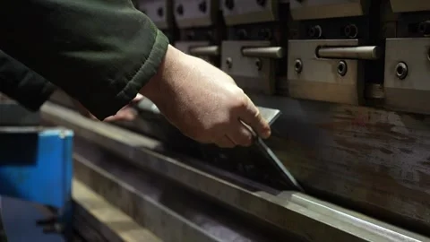 Close up the bending machine operator hold the sheet metal parts Stock Footage 300759815