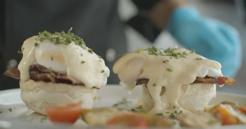 Close-up of Benedict's egg sprinkled with greens. 4K video in slow motion Stock Footage 103584567