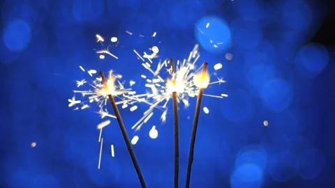 Close-up, Bengal fire sparks floating on a blue background 스톡 동영상 121521635