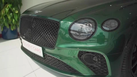 Close-up of the Bentley's front bumper. A green new car. Video stock 244732435