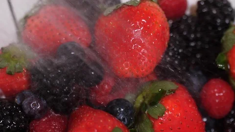 Close up  of berries being washed with a spray of water in 4k Stock Footage 86536681