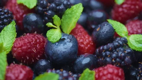 Close up of berries with green leaves being sprayed with water Stock Footage 276384776
