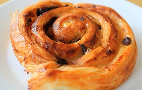 Close up beside view of raisin bread on white dish. Stock Photos