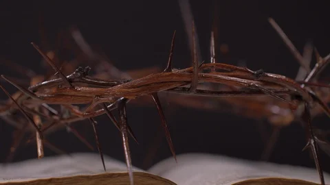 Close Up of Bible and Crown of Thorns Rotating on Black Background Video stock 129642323