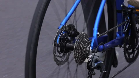 Close-up of bicycle gears and chain spinning in sunlight. 4K. Stock Footage 328629246