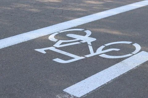 Close-up of a bicycle pattern on cracked asphalt Stock Photos