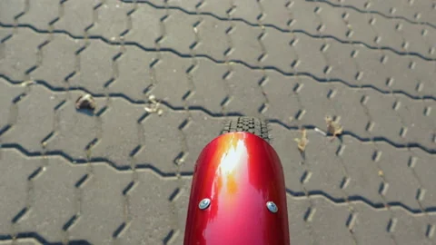 Close-up of a Bicycle wheel rolling on the pavement slab Vídeos de archivo 96454304