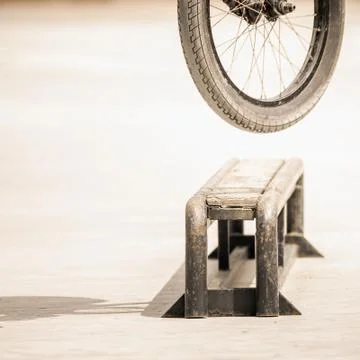 Close-up of bicycle wheels doing trick by rail Stock Photos