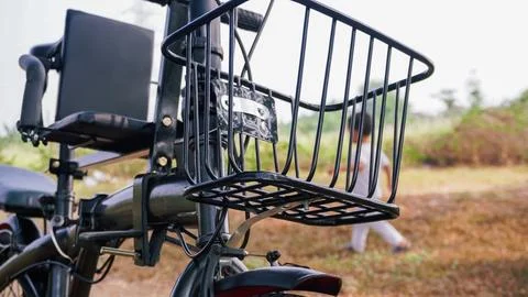 Close-up of a bicycle's front basket and seat, set against a blurred natura.. Stock Photos