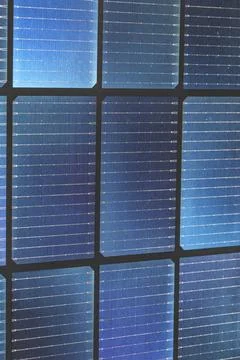 Close up of bifacial solar panel cells with blue grid texture and black frame Stock Photos