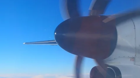 Close up big black airplane propeller moving, flying in clear blue sky Stock Footage 89905482