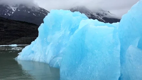 Close up of a big blue pieces of glacier in a mountain cold lake in Patagonia in Stock Footage 264942882