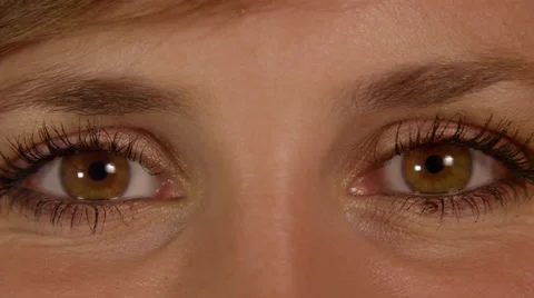 CLOSE UP: Big brown eyes looking directly at camera smiling Stock Footage 45994602