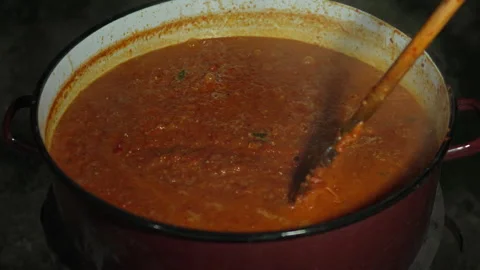 Close up on big cooking pot prepare ajvar balkan serbian national dish Stock Footage 249525705