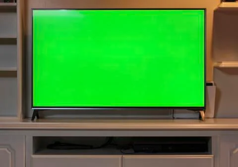 Close up of big green screen led TV in a cozy living room. Stock Photos