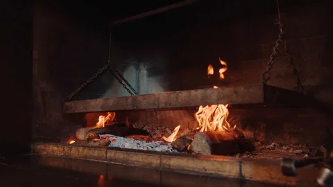 Close up big grill in restaurant red fireplace meat slices roasting on bbq Stock Footage 100307331
