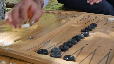 Close-up big hands of senior man and young hands of a teenager play backgammon Video stock 194813739