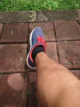 Close up, Big Man Leg Using Blue Sport Shoes Stock Photos