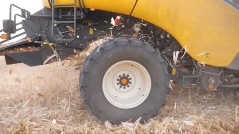 Close up big rotating wheel of combine working on corn field or farm. Harvester Video stock 327941790