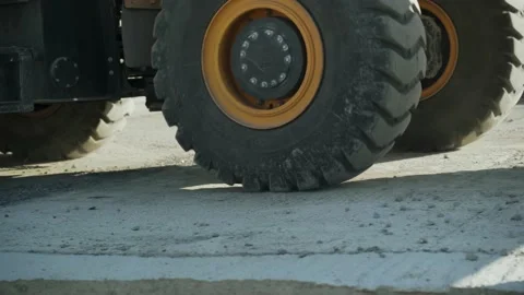 Close-up of big rotating wheels of working tractor Stock Footage 171409694