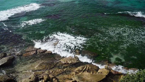 Close up big waves beat on the rocky shore Stock Footage 124907779