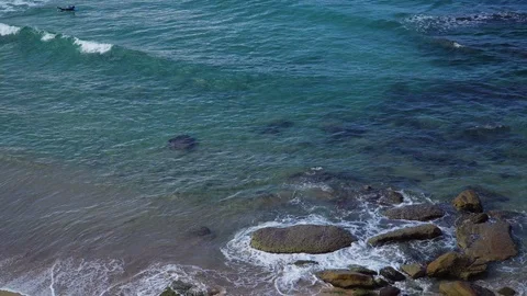 Close up big waves beat on the rocky shore Stock Footage 124973976