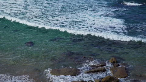 Close up big waves beat on the rocky shore Stock Footage 124974252