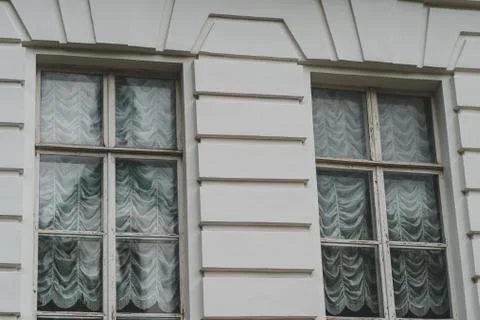Close up of big windows of manor. Texture of windows of historic white Palace. Stock Photos