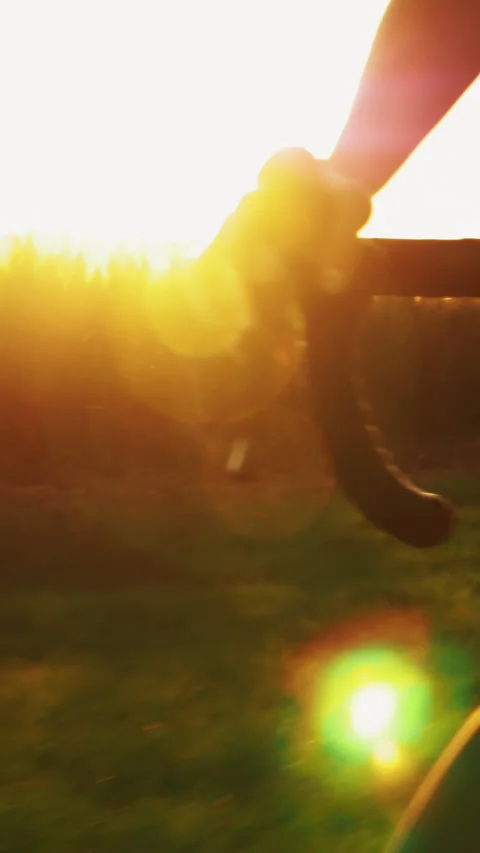 Close up of bike handlebar in sunset light. Vertical video Stock Footage 311322962