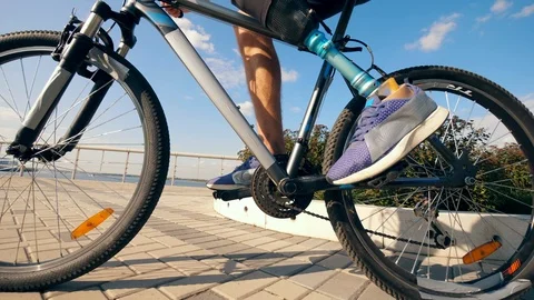 Close up of bike pedals getting spinned by a man with a bionic leg Stock Footage 116802290