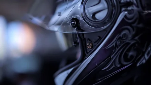 Close up, the biker closes his helmet. on a dark background, motorcyclist's prot Stock Footage 129392707