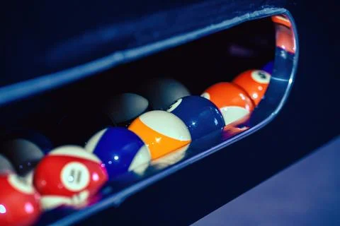 Close Up Of Billiard Balls In The Pocket Of A Pool Table Stockfoto's