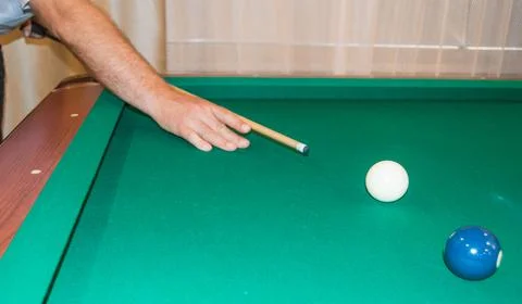 A close-up of a billiard table with balls pointing the athlete's hands befo.. Stock-Fotos