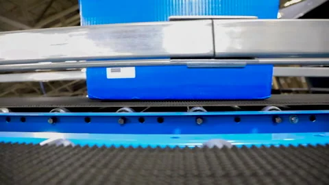 Close up of a Bin Moving Down A Conveyor Belt in Shipping Distribution Wareho Vídeo Stock 167560657