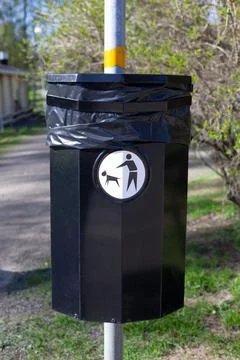 Close up of a bin specifically used for disposing of dog waste conceptualising Stock Photos