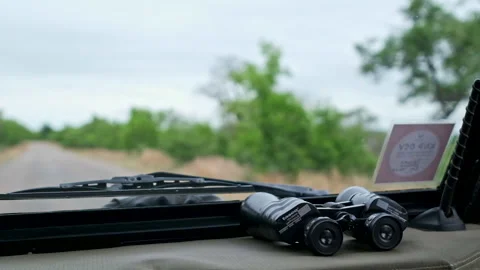 Close up of binoculars on the dash board in a moving car Stock Footage 240923268