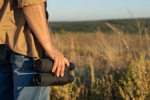 Close up of binoculars in a man's hand Foto stock
