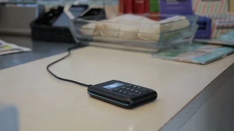 Close up of bionic hand touching payment terminal. Video stock 92353443