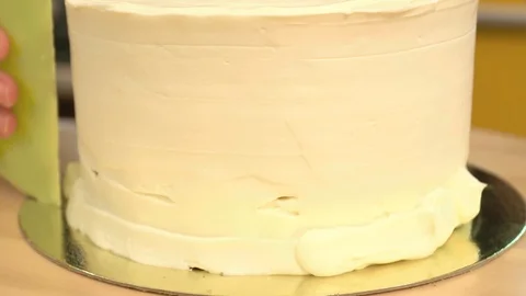 Close-up: biscuit cream in the form of a spiral on the cake. Chocolate sponge Stock Footage 87050331