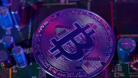 Close-up of Bitcoin Coin on Circuit Board Stock Footage 328169997