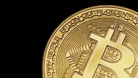 Close-up of a Bitcoin coin showcasing intricate designs symbolizing digital Stock Footage 312604053