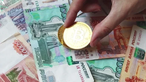 A close-up of Bitcoin coins and Russian rubles banknotes Stock Footage 281513169