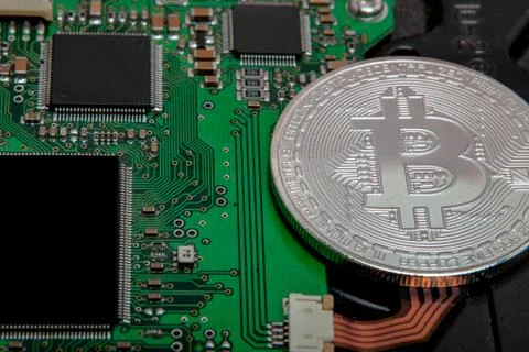 Close-up of bitcoin, computer circuit board with bitcoin processor and microc 스톡 사진