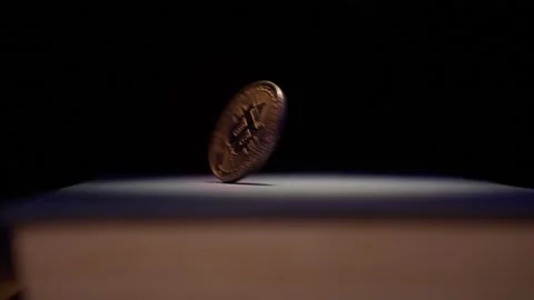Close up bitcoin spins coin with dark textured background.Digital Currency. Stock Footage 322085987