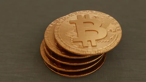 Close up of bitcoins falling and landing in a stack Stock Footage 164499646