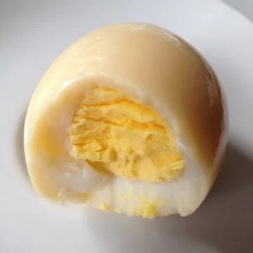 Close up of bite of hard boiled egg Stock Photos