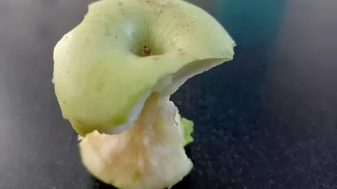 Close-up of a Bitten Granny Smith Apple Isolated on Black Stock Footage 332176590