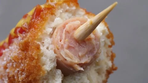 Close-up of a Bitten Korean Corn Dog with Hot Dog and Wooden Stick Video stock 343587733