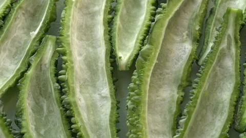 Close-up of bitter melon halves prepared for cooking. Video stock 346188768