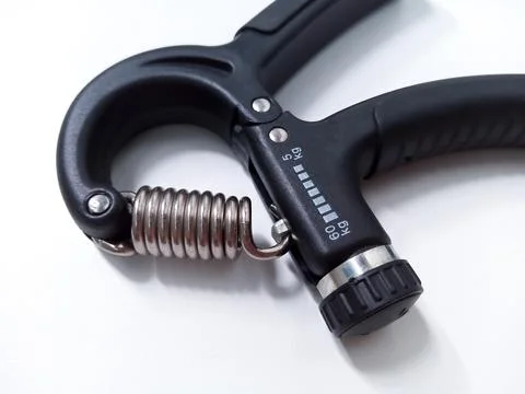 Close up Black Adjustable Hand Grip Strengthener Isolated On White Backgrou.. Stock Photos